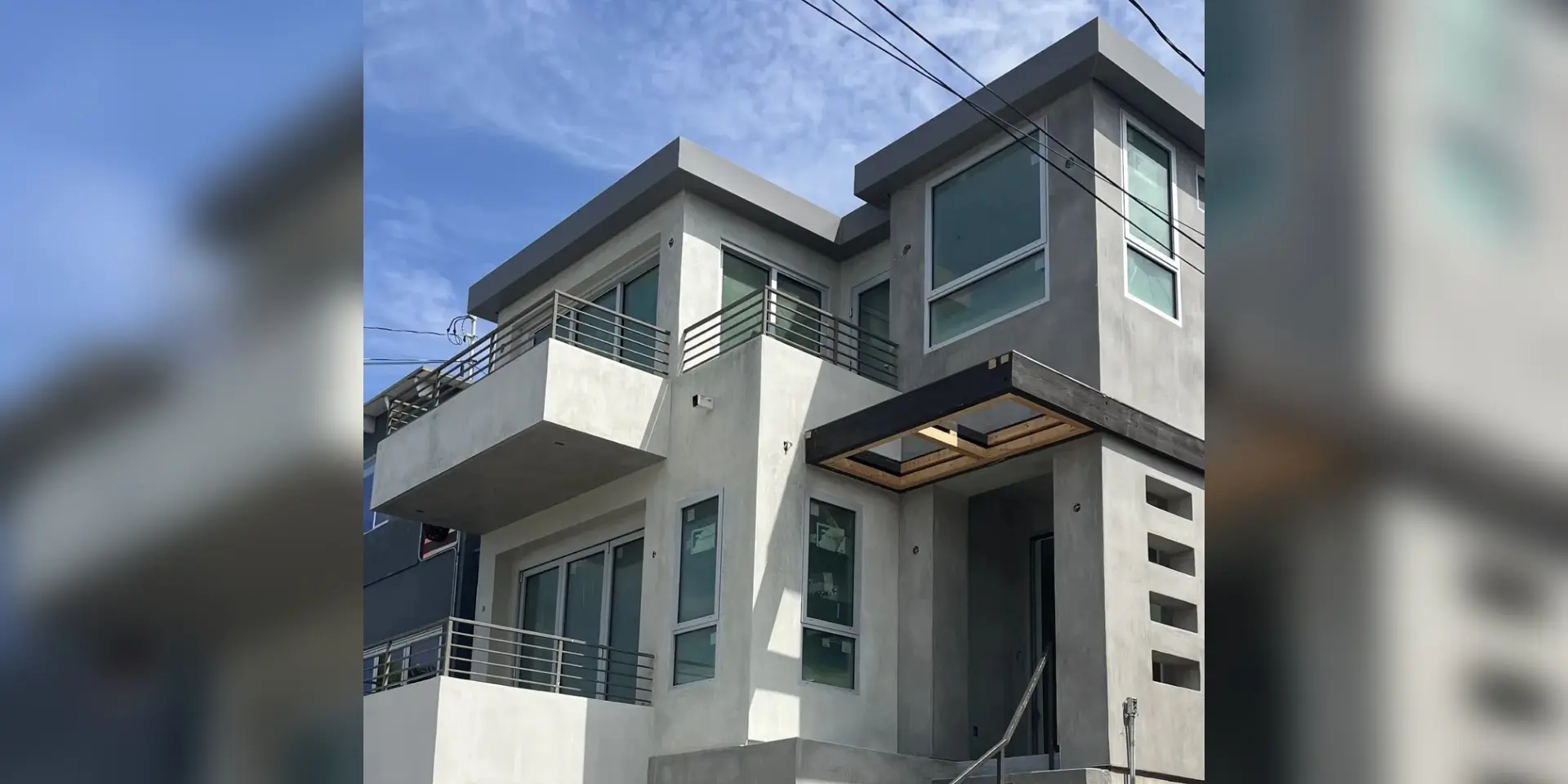 A large modern style house with a balcony.